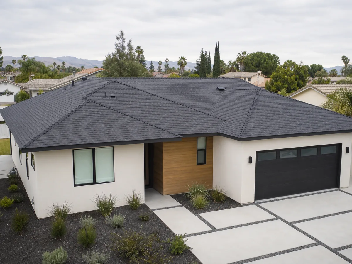 Illustrative charcoal shingle-roof installation on a contemporary home