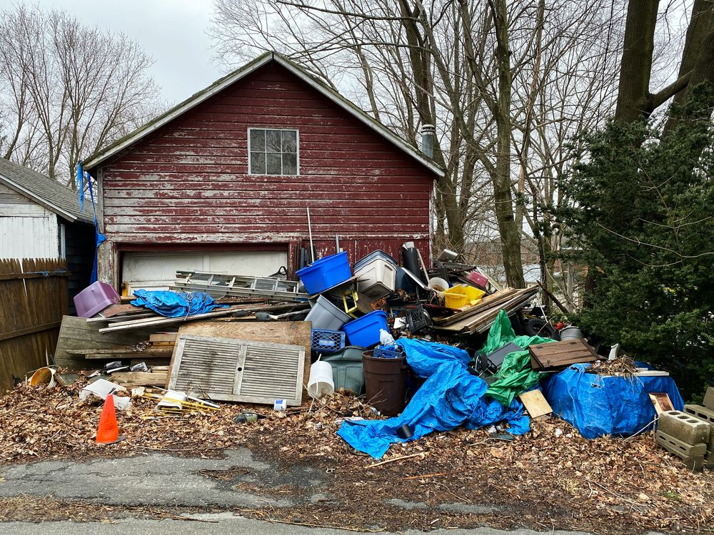 Property piled with unwanted items before junk removal
