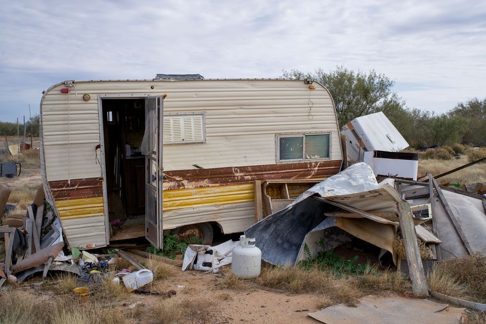 Old appliances and household junk staged for removal