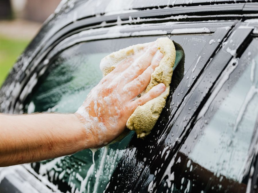 Car being hand washed with a microfiber mitt