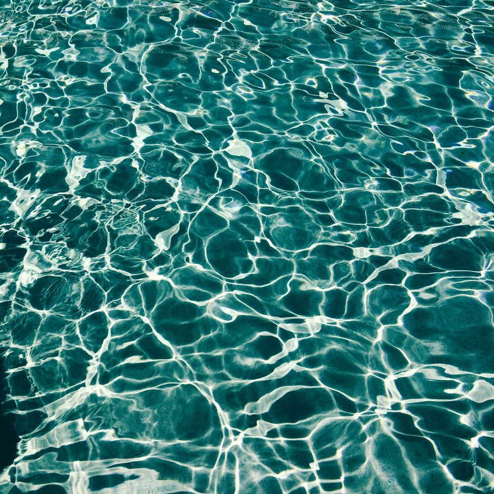 Crystal-clear rippling pool water